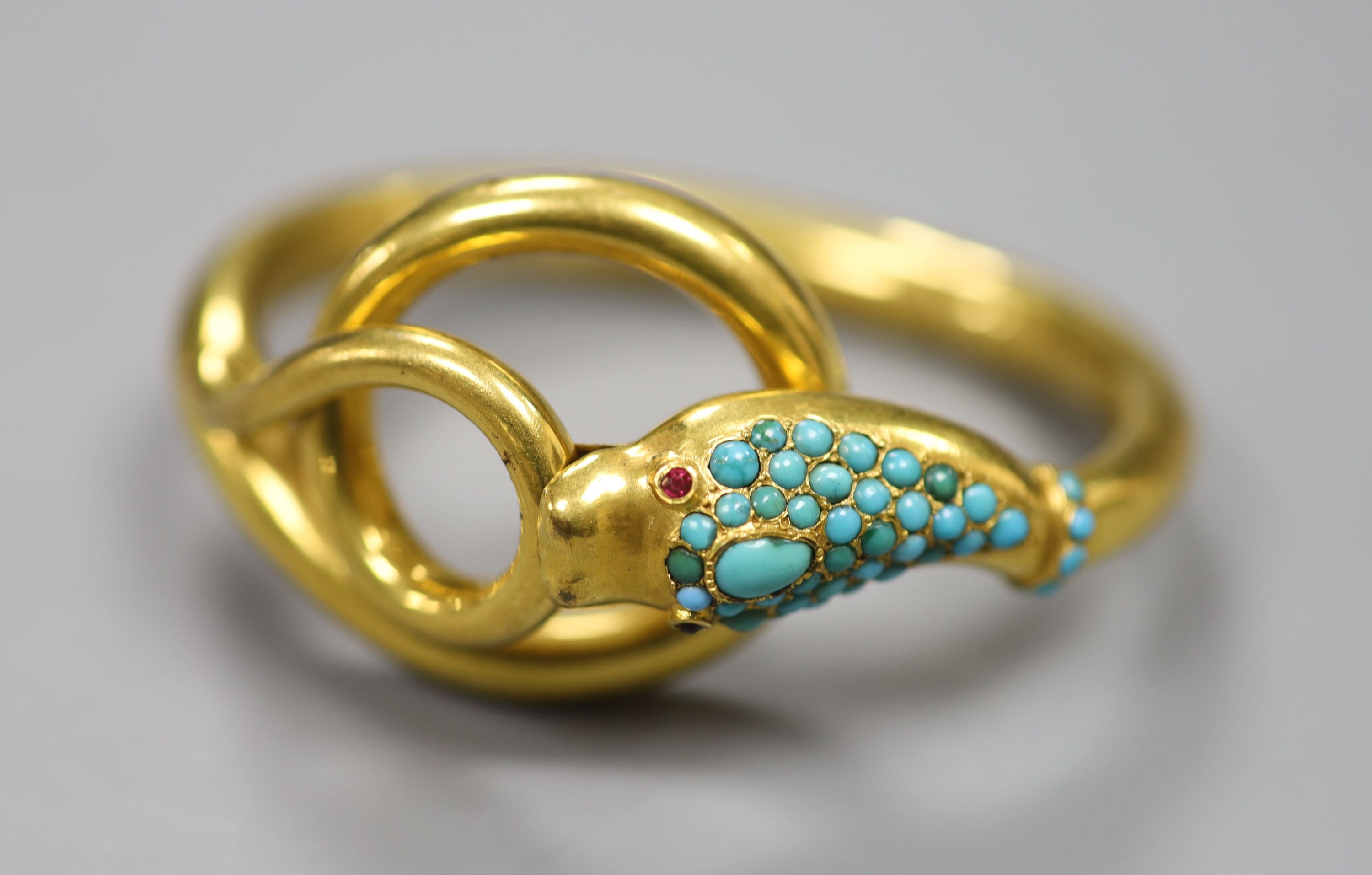 A Victorian pinchbeck and turquoise set hinged serpent bangle, with gem set eyes.